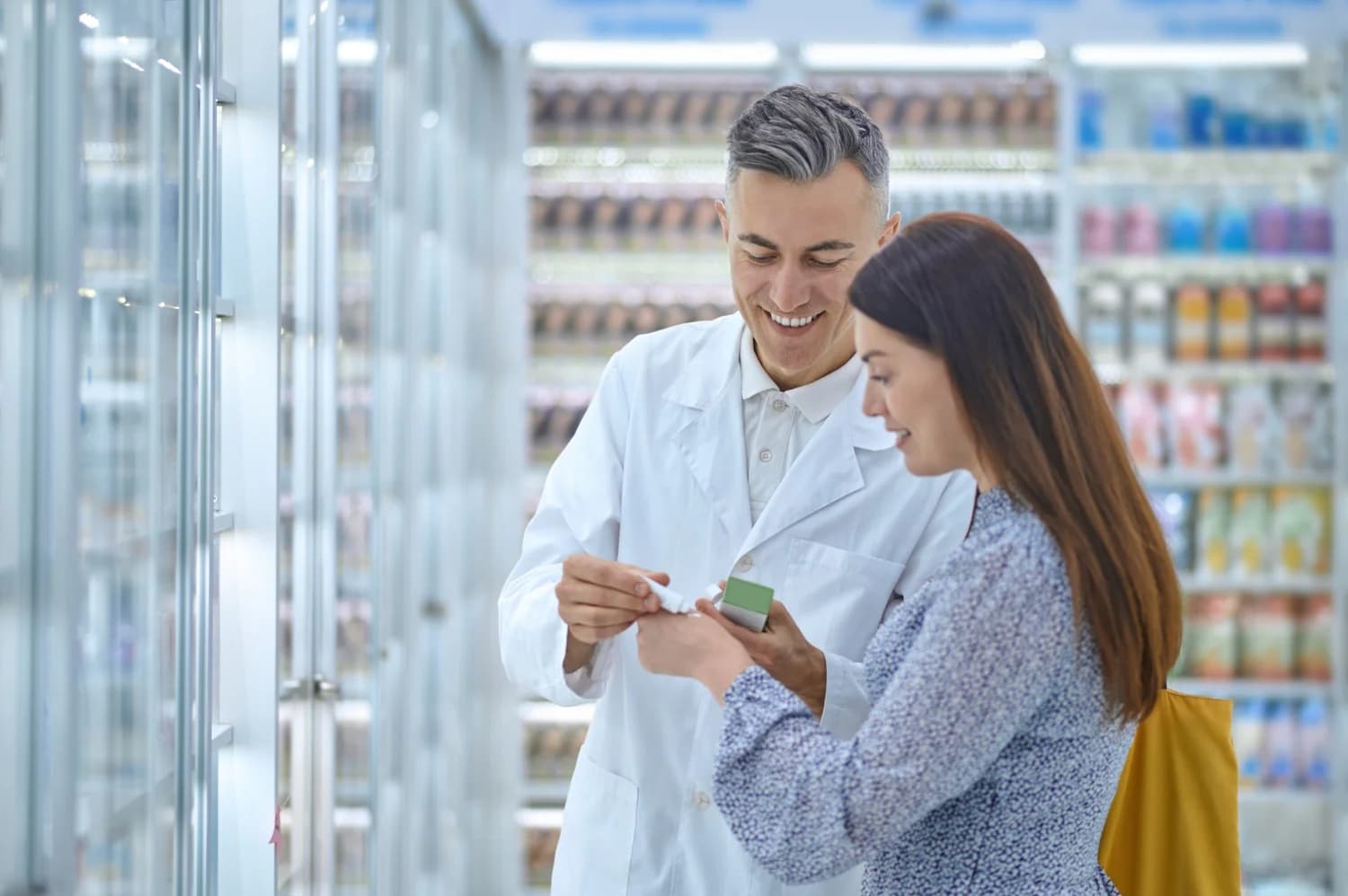 A pharmacist advising a customer at the counter